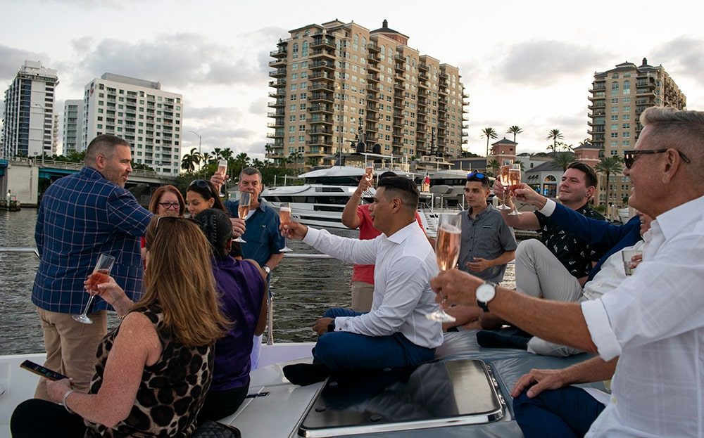 Guests toasting at sunset on the bow
